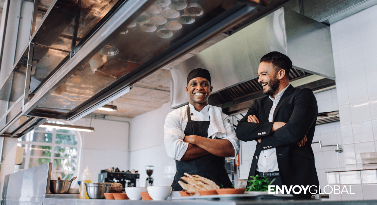 Image of two chef's in a kitchen with the Envoy Global logo. 