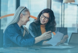 2026 U.S. Corporate Immigration Trends Report — two professionals review key U.S. corporate immigration trends shaping workforce mobility and employer planning for the year ahead.